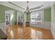 Well-lit dining room with hardwood floors, chandelier, and access to the living room at 3544 Candytuft Run, Auburn, GA 30011