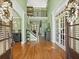 Spacious foyer entrance with hardwood floors, open staircase, high ceilings, and large French doors with lots of natural light at 3544 Candytuft Run, Auburn, GA 30011