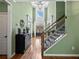 Grand foyer boasting high ceilings, hardwood floors, and staircase with wrought iron spindles at 3544 Candytuft Run, Auburn, GA 30011