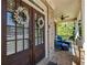 Inviting front porch with double doors, stone pillars, and cozy seating area for relaxing at 3544 Candytuft Run, Auburn, GA 30011