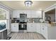 Updated kitchen featuring white cabinets, stainless appliances, and backsplash at 3544 Candytuft Run, Auburn, GA 30011