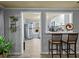Kitchen featuring breakfast bar with seating, stainless appliances, and modern lighting at 3544 Candytuft Run, Auburn, GA 30011