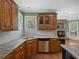 Kitchen featuring granite countertops and backsplash, stainless steel dishwasher, and wood cabinetry at 3544 Candytuft Run, Auburn, GA 30011