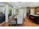 Open concept kitchen and dining area with stainless steel appliances and hardwood floors at 3544 Candytuft Run, Auburn, GA 30011