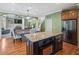 A large kitchen with granite countertops, stainless steel appliances, and hardwood floors that opens to living area at 3544 Candytuft Run, Auburn, GA 30011