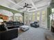 Comfortable living room with lots of windows, fireplace and dark leather furniture at 3544 Candytuft Run, Auburn, GA 30011