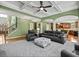 Spacious living room featuring a coffered ceiling, plush seating, and seamless transition to the kitchen at 3544 Candytuft Run, Auburn, GA 30011