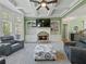 Cozy living room featuring a stone fireplace, built-in shelving, and comfortable seating at 3544 Candytuft Run, Auburn, GA 30011