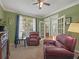 Inviting living room with red reclining chairs, carpet floors, and natural light at 3544 Candytuft Run, Auburn, GA 30011