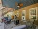 Cozy outdoor patio featuring comfortable seating, ceiling fan, and rustic charm for relaxation and entertainment at 3544 Candytuft Run, Auburn, GA 30011