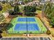 Aerial view of community tennis courts with well-maintained blue and green surfaces at 3544 Candytuft Run, Auburn, GA 30011
