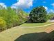 Large, well-maintained lawn with mature trees located in a quiet neighborhood at 3544 Candytuft Run, Auburn, GA 30011