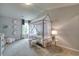 bedroom with a unique canopy bed, neutral carpet, and grey accent wall with decorations at 700 Relic Rdg, Hampton, GA 30228