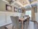 Elegant dining room with coffered ceilings, chandelier, and wainscoting at 700 Relic Rdg, Hampton, GA 30228