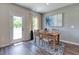 Cozy dining area featuring a wooden table, rug, and view to the backyard at 700 Relic Rdg, Hampton, GA 30228