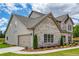 Spacious home featuring a two-car garage, brick accents, and professionally landscaped grounds at 700 Relic Rdg, Hampton, GA 30228