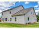 Expansive home exterior showcasing lush green lawn and pristine siding at 700 Relic Rdg, Hampton, GA 30228