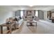 Spacious living room with plush seating, neutral carpet, and natural light from two windows at 700 Relic Rdg, Hampton, GA 30228