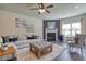 Inviting living room featuring a fireplace, ceiling fan, neutral colors, and an area rug at 700 Relic Rdg, Hampton, GA 30228