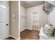 Mud room featuring wood floors, bench seating, a storage area, and a door leading to a walk-in closet at 700 Relic Rdg, Hampton, GA 30228