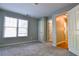 Comfortable bedroom with carpet, doors to other rooms, and natural lighting at 974 Regal Hills Ln, Mableton, GA 30126