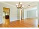 Hardwood floors accentuate a formal dining room with wainscoting and an elegant chandelier, perfect for entertaining guests at 974 Regal Hills Ln, Mableton, GA 30126