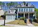 Charming two-story home with a welcoming porch, blue siding, and a two-car garage at 974 Regal Hills Ln, Mableton, GA 30126