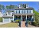 Charming two-story home featuring dormer windows, blue siding, and a welcoming front porch with matching trim at 974 Regal Hills Ln, Mableton, GA 30126