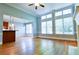 Bright living room features hardwood floors, crown molding, and many large windows at 974 Regal Hills Ln, Mableton, GA 30126