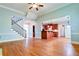 Open-concept living room with hardwood floors, staircase, and view into the kitchen at 974 Regal Hills Ln, Mableton, GA 30126