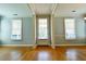 Open-concept living space features hardwood floors and an abundance of natural light, offering versatile living options at 974 Regal Hills Ln, Mableton, GA 30126