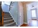 Carpeted stairs with decorative railings lead to the upper level of the home at 974 Regal Hills Ln, Mableton, GA 30126