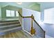 View of the carpeted staircase with wood and wrought iron banister at 974 Regal Hills Ln, Mableton, GA 30126