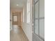 Hallway with light-colored wood floors, white trim, and windowed entry door at 120 Winsome Way, Woodstock, GA 30188