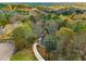 Expansive aerial view of the estate with winding drive, lush fall foliage and picturesque surroundings at 270 Boulder Dr, Roswell, GA 30075