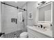 Modern bathroom featuring sleek fixtures, a glass-enclosed shower, and black and white tile at 270 Boulder Dr, Roswell, GA 30075