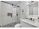 Modern bathroom featuring sleek fixtures, a glass-enclosed shower, and black and white tile at 270 Boulder Dr, Roswell, GA 30075