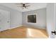 Bright bedroom featuring a ceiling fan, large window, and a door at 270 Boulder Dr, Roswell, GA 30075