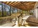 Spacious wooden deck featuring railings, stairs, and a stunning view of surrounding forest and nature at 270 Boulder Dr, Roswell, GA 30075