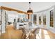 Bright, modern dining room featuring hardwood floors, stylish lighting, and access to an outdoor deck at 270 Boulder Dr, Roswell, GA 30075