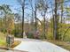 View of the driveway leading up to the home, showcasing landscaping and natural surroundings at 270 Boulder Dr, Roswell, GA 30075
