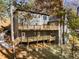 Two story rear exterior of home with multi-level wooden decks and beautiful wooded landscape at 270 Boulder Dr, Roswell, GA 30075