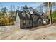 Charming two-story home features a stone and stucco facade, multiple windows, and an attached garage at 270 Boulder Dr, Roswell, GA 30075