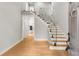 Bright foyer features hardwood floors, staircase with glass railing and views of the kitchen at 270 Boulder Dr, Roswell, GA 30075