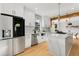 Modern kitchen with stainless steel appliances, marble countertops, white cabinets, and a kitchen island at 270 Boulder Dr, Roswell, GA 30075