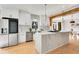 Contemporary kitchen features stainless steel appliances, white cabinets, marble countertops, and a spacious island at 270 Boulder Dr, Roswell, GA 30075