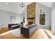 Bright living room featuring a stone fireplace, high ceilings, and natural light from large windows at 270 Boulder Dr, Roswell, GA 30075