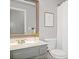 Neutral bathroom features a large vanity mirror, gray cabinets, and a white toilet and shower with a curtain at 2009 Westside Ln, Woodstock, GA 30189