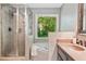 Bathroom showcasing a glass-enclosed shower, soaking tub, and serene outdoor views at 2009 Westside Ln, Woodstock, GA 30189
