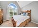 Bright bedroom featuring a large arched window, neutral walls, and a cozy bed with decorative pillows at 2009 Westside Ln, Woodstock, GA 30189